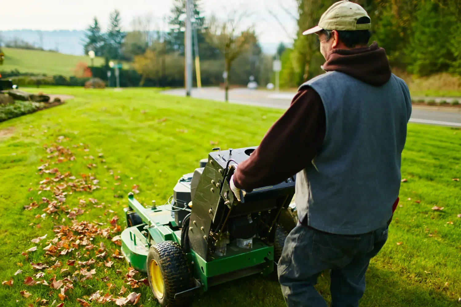 Landscape designer trimming shrubs during spring cleanup in Seattle, WA