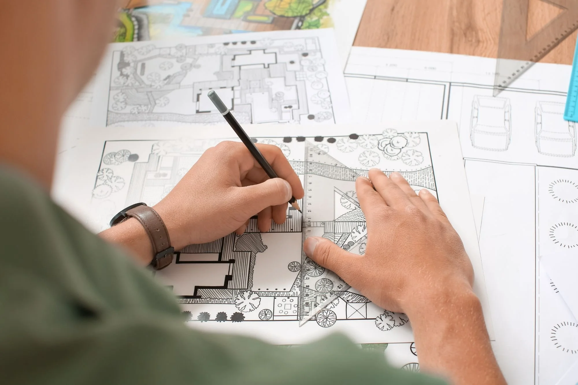 Landscape design plans being reviewed and marked up for a residential landscaping project in Kirkland, WA