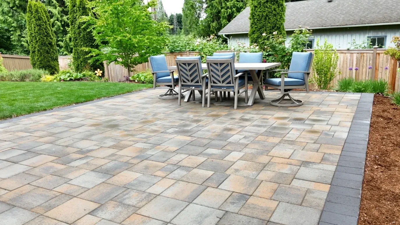 Custom paver patio with outdoor dining furniture designed by a landscape designer in Seattle, WA