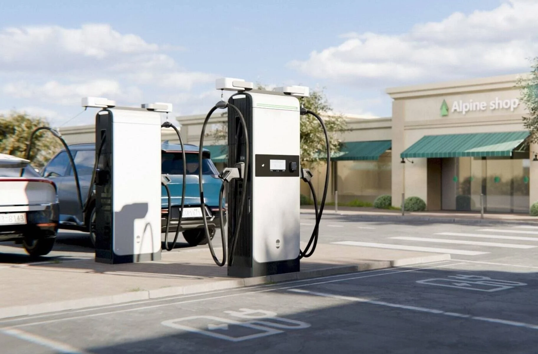 Electric vehicle charging station in a parking lot with cars and a shopping center in the background.
