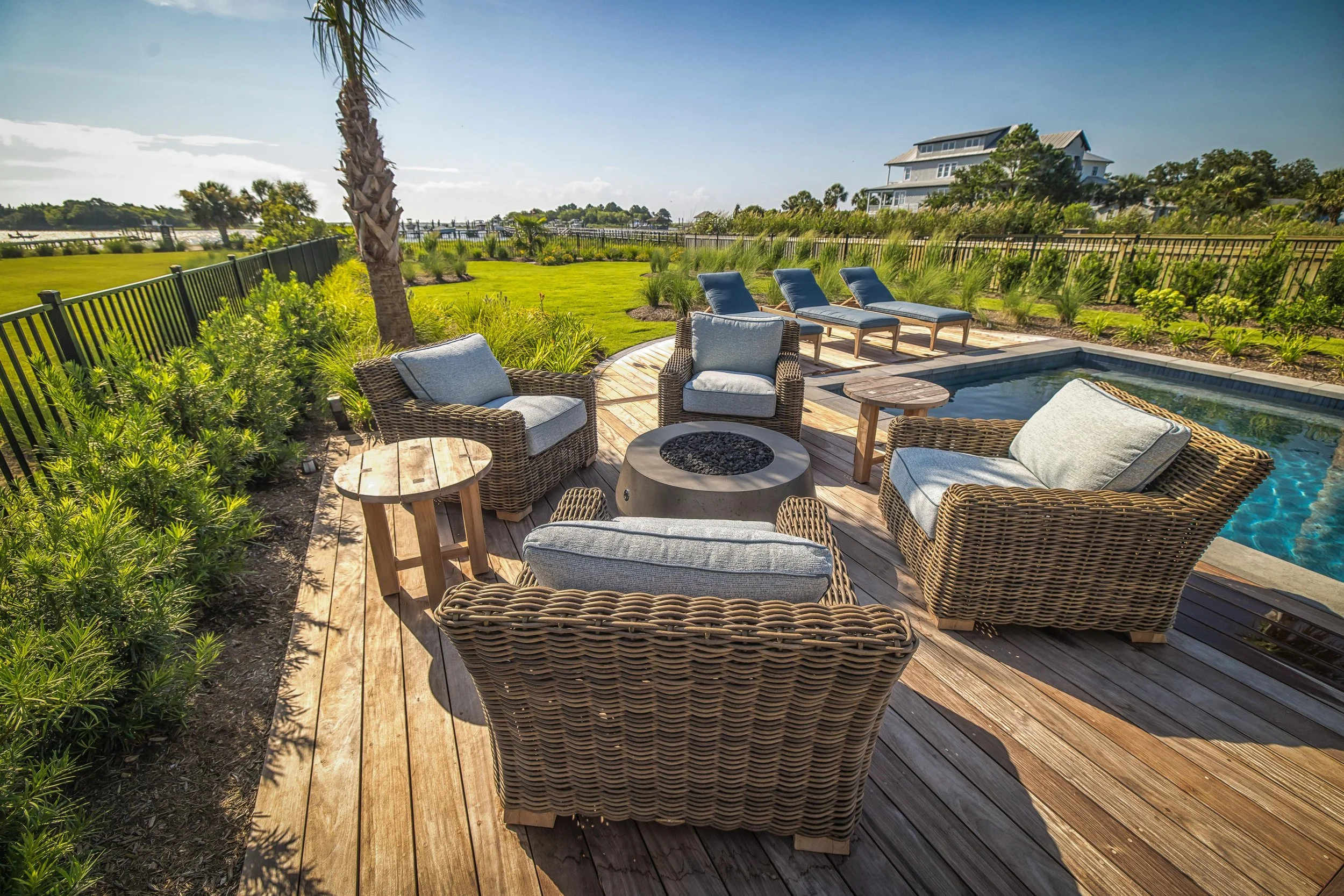 Outdoor fireplace framed by professional landscape design in Landfall, NC