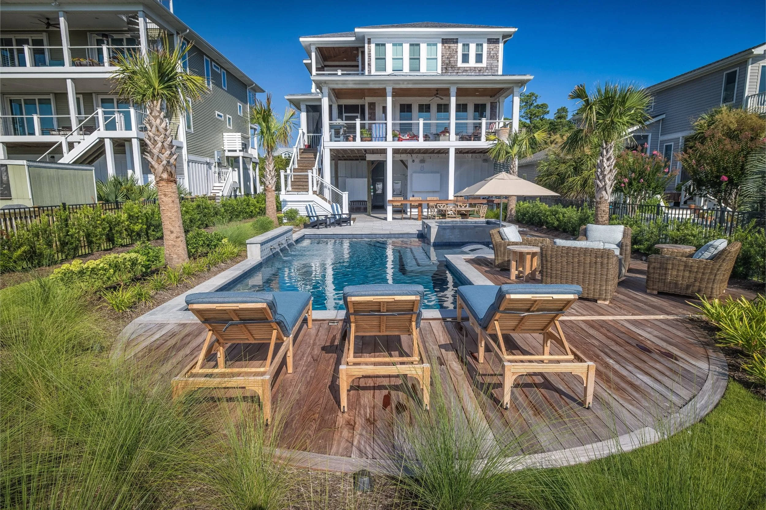 A luxury outdoor living retreat with pool and shaded seating in Hampstead, NC