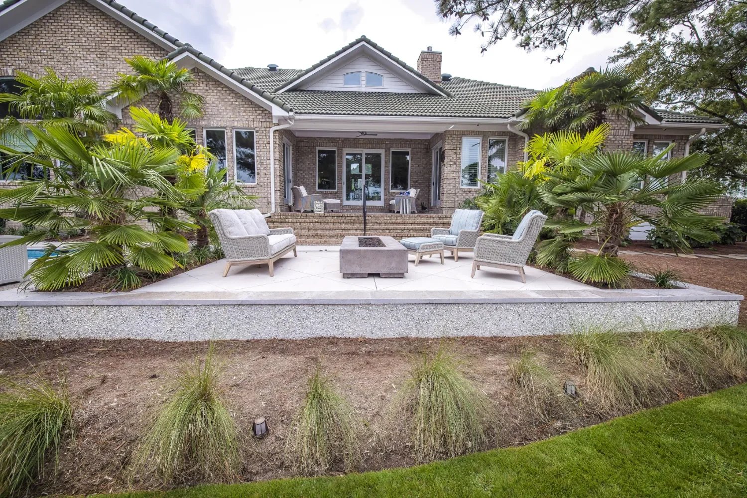 Garden-focused landscape design around a small patio in Wrightsville Beach, NC