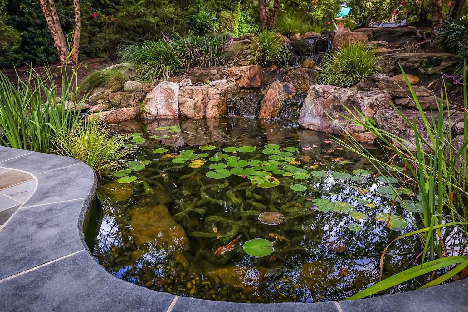 Outdoor living pondless waterfall with landscape design in Hampstead, NC