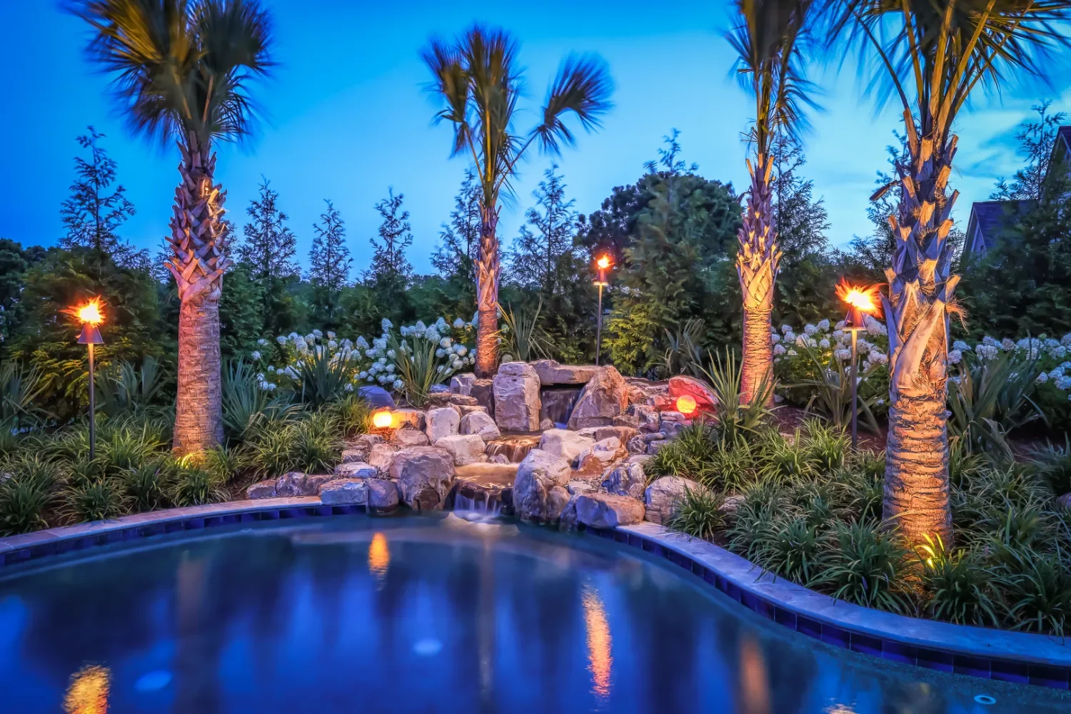 Outdoor lighting illuminating stone borders and plantings in Wilmington, NC