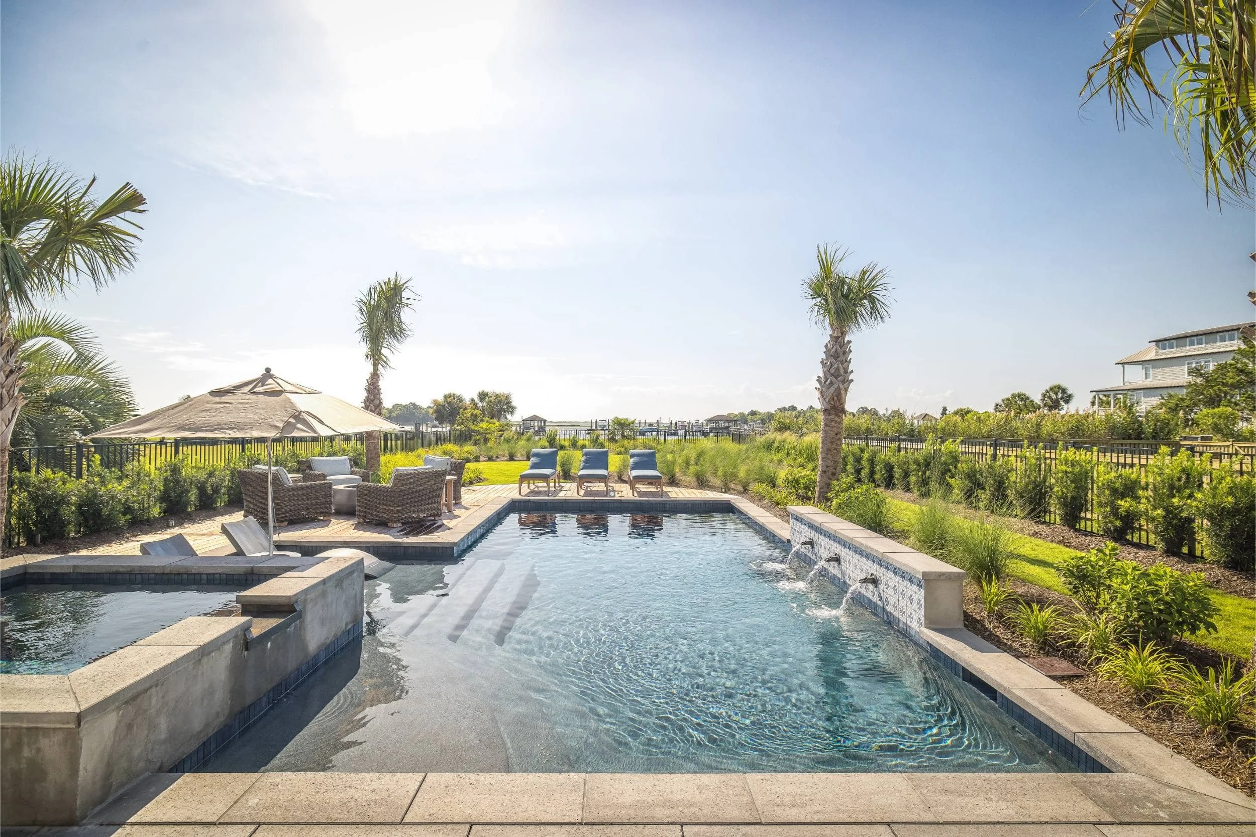 A luxury outdoor living design with pool and spa in Myrtle Grove, NC