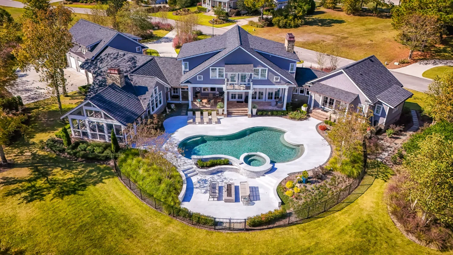 Landscape design in Landfall, NC with structured planting beds, mature trees, and refined transitions around a residential home