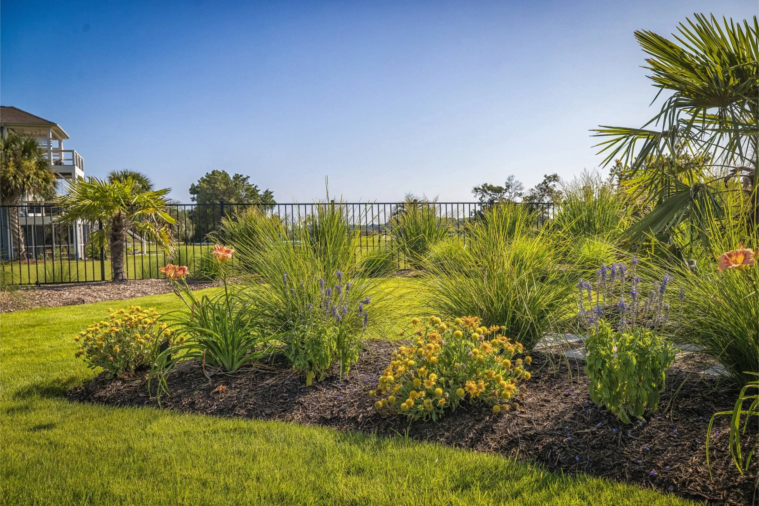A custom outdoor living space with pool and spa overlooking the water in Kure Beach, NC