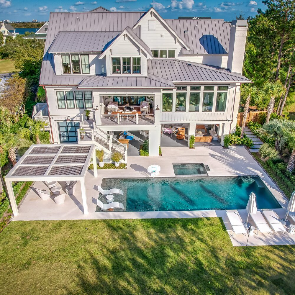 Outdoor living space with clean coastal hardscaping in Figure Eight Island, NC
