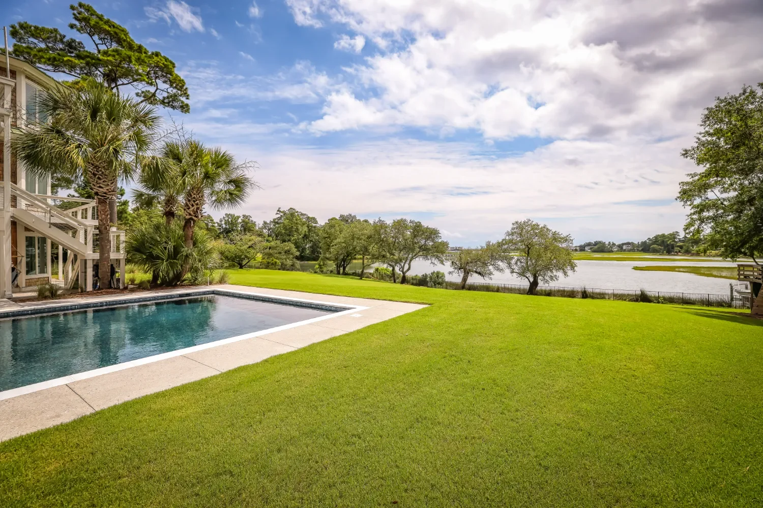 Backyard lawn care and landscape design around a pool in Kure Beach, NC