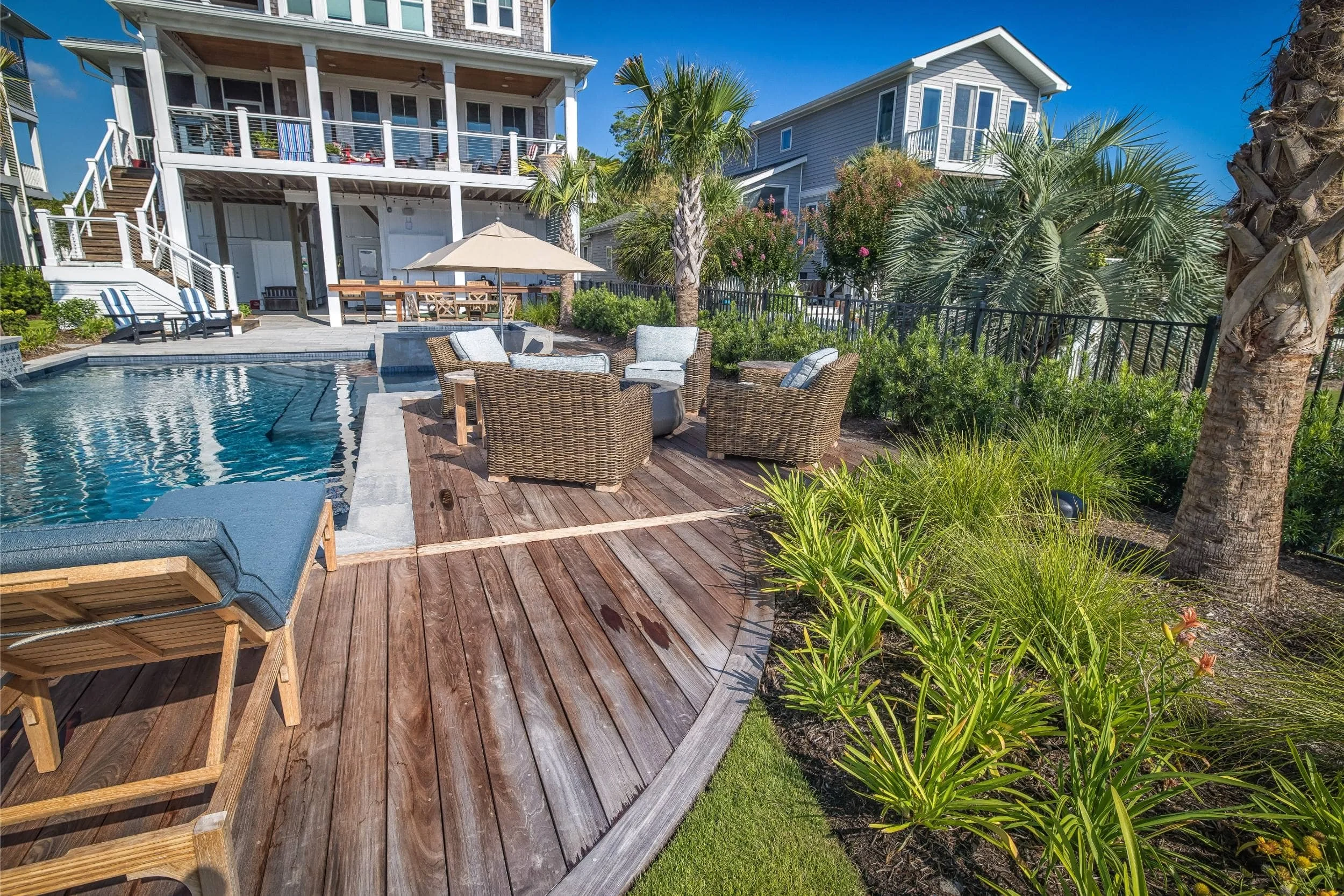 A custom landscaping near me project with lush coastal plantings in Kure Beach, NC