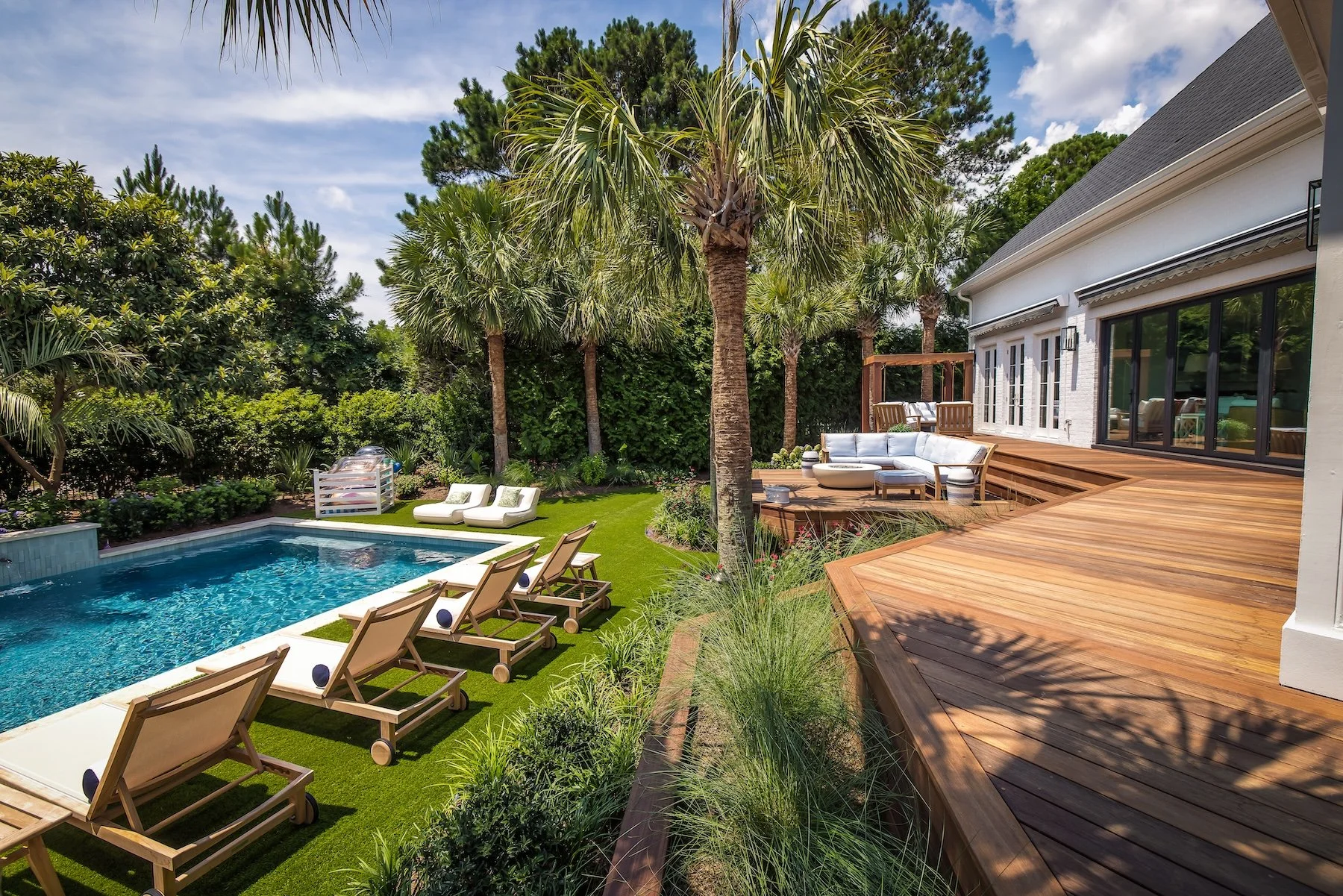Decking, inground pool, water feature, and turf installation in Wilmington, NC