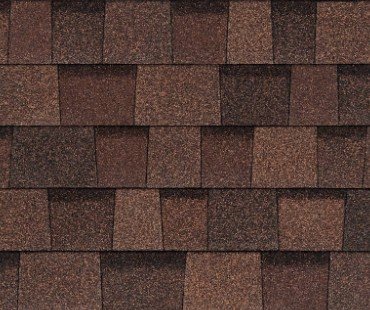 Close-up of a brown shingle roof with overlapping rectangular shingles.