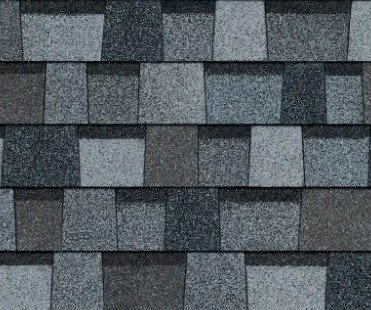 Close-up of a rooftop with gray asphalt shingles arranged in overlapping rows.