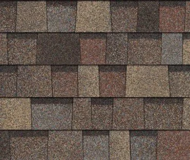 Close-up of a roof with asphalt shingles in various shades of brown and gray.