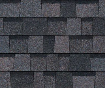 Close-up of gray asphalt shingles on a rooftop