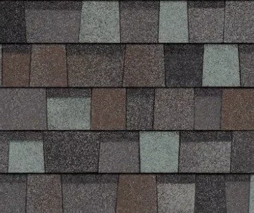 Close-up of a tiled roof with asphalt shingles in various shades of gray and brown.