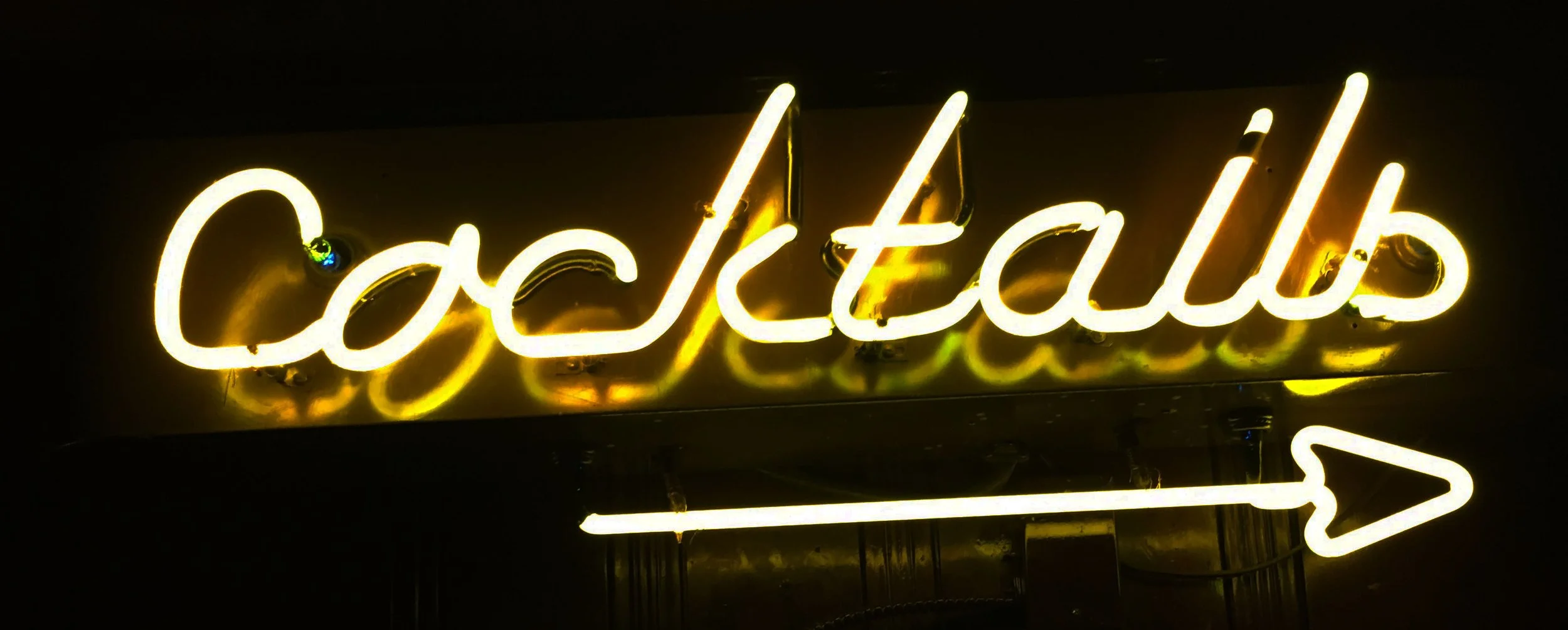Neon sign reading 'Cackleballs' with an arrow pointing to the right.