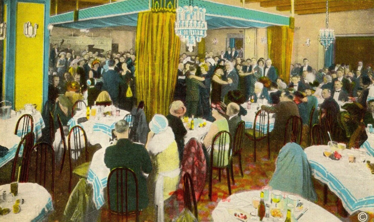 A lively indoor ballroom scene with many people dancing and sitting at tables. The scene appears to be from a past era, with women wearing hats and dresses, and men in suits. There are chandeliers hanging from the ceiling and a large curtain dividing the dance floor from the dining area.