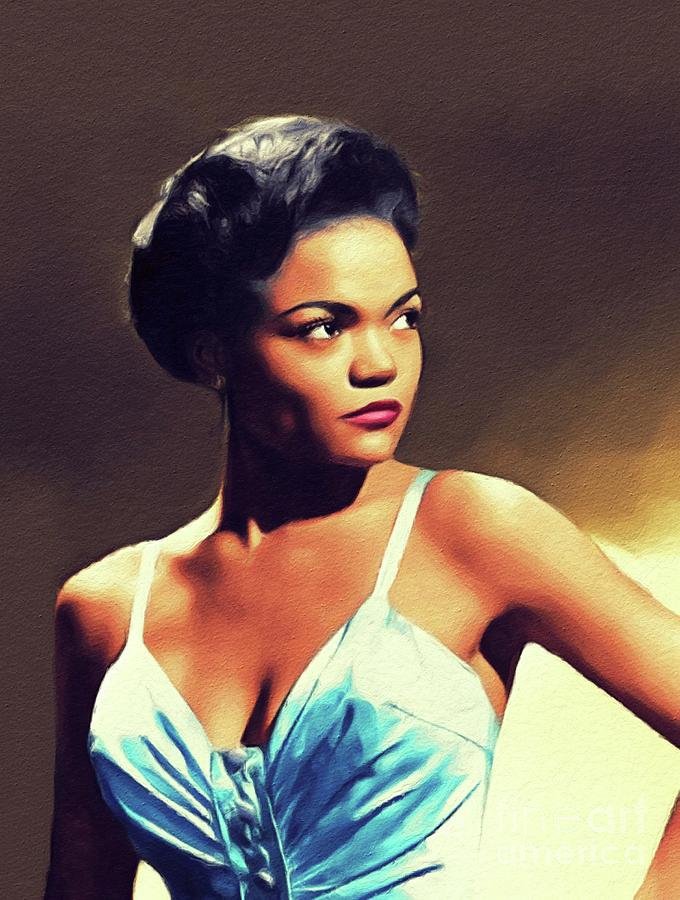 A woman with dark hair styled in an elegant updo, wearing a blue satin dress with thin straps, posing against a dark background.