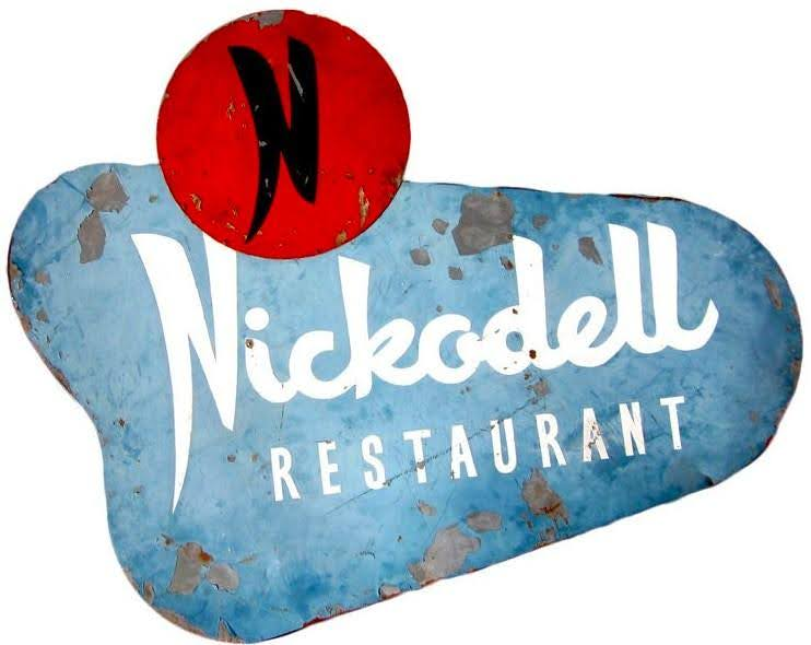 Nickelodeon restaurant logo on a weathered, blue background with a red circle and black 'N' symbol.