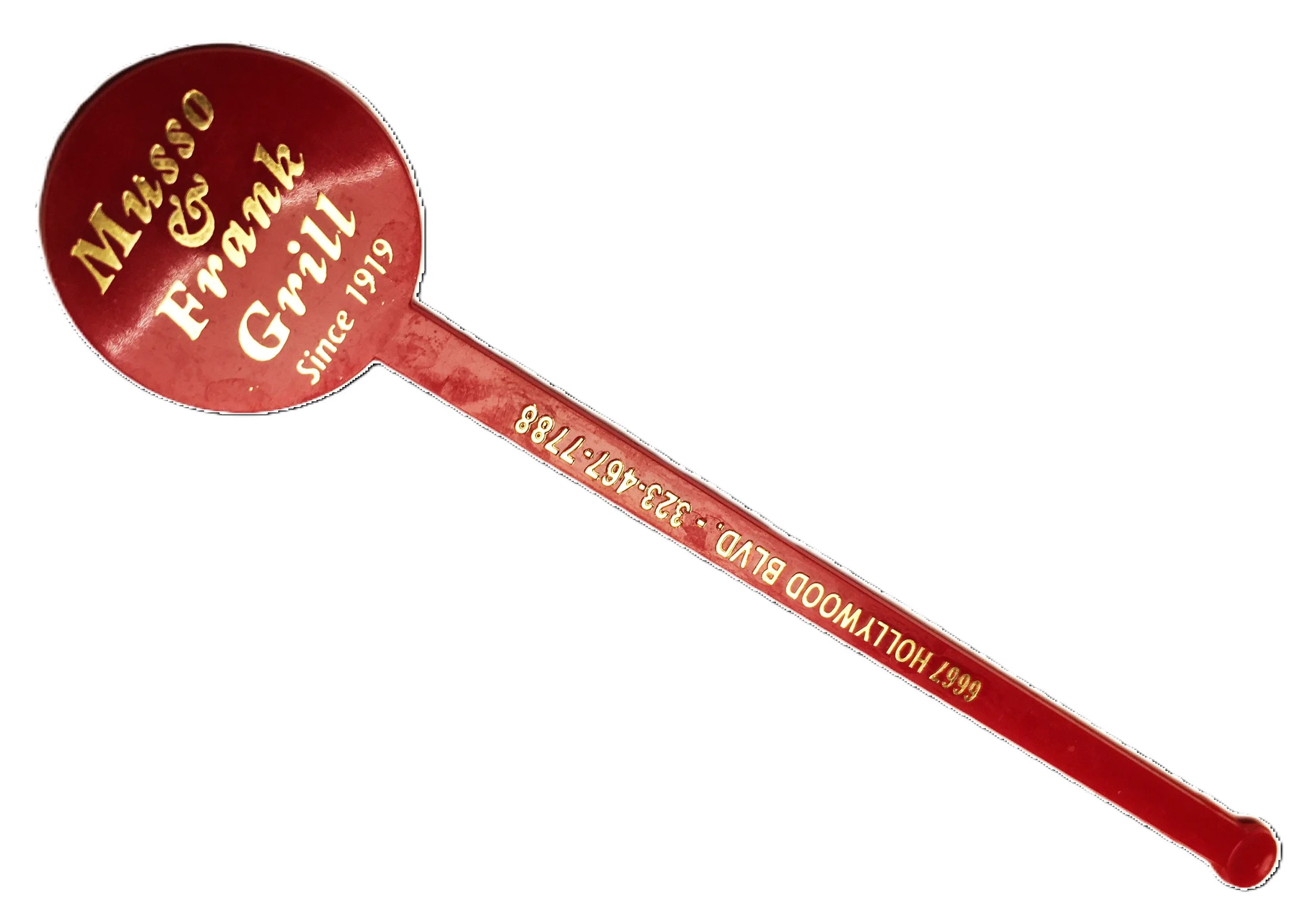 Red souvenir spoon with gold lettering that says 'McWesso & Enfield since 1919' on the bowl and '6667 HOLLYWOOD BLVD. 222-4567-1888' on the handle.