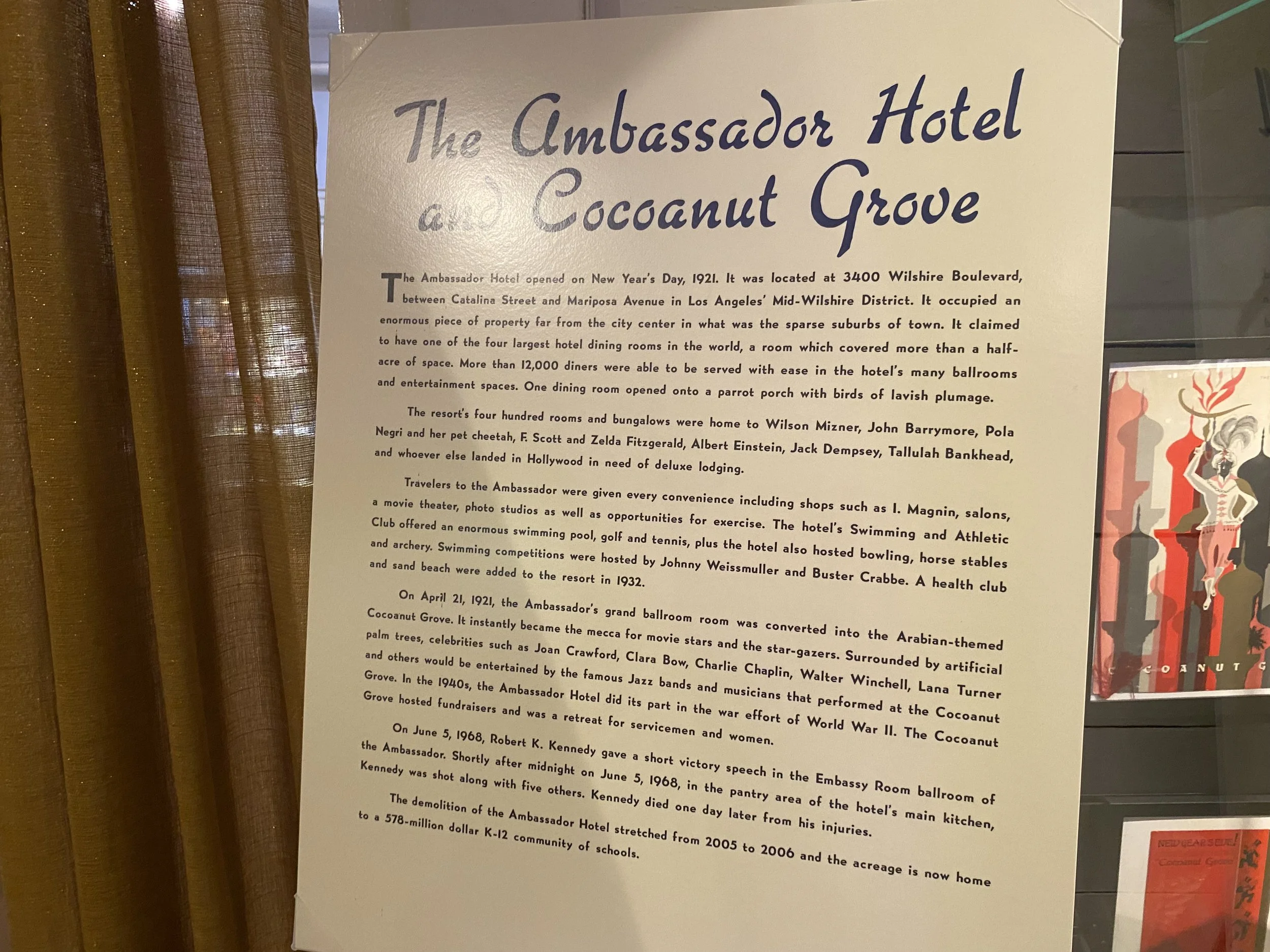 Informational sign about The Ambassador Hotel and Coconut Grove, including its history, notable guests, events, and demolition.