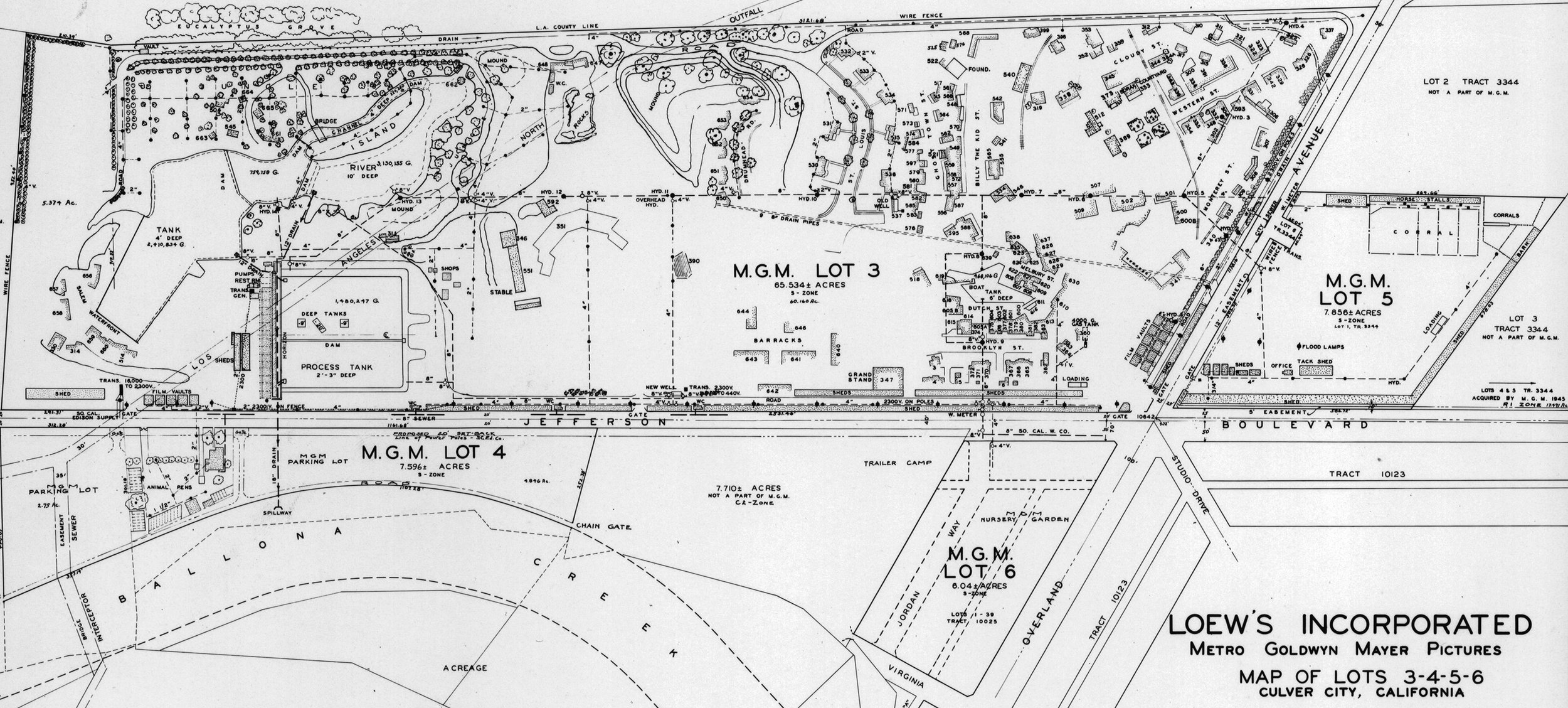 A detailed black-and-white blueprint map of a land subdivision with numbered lots, roads, and various features including water tanks, tanks, drainage systems, and parking areas, labeled with lot numbers and measurements.