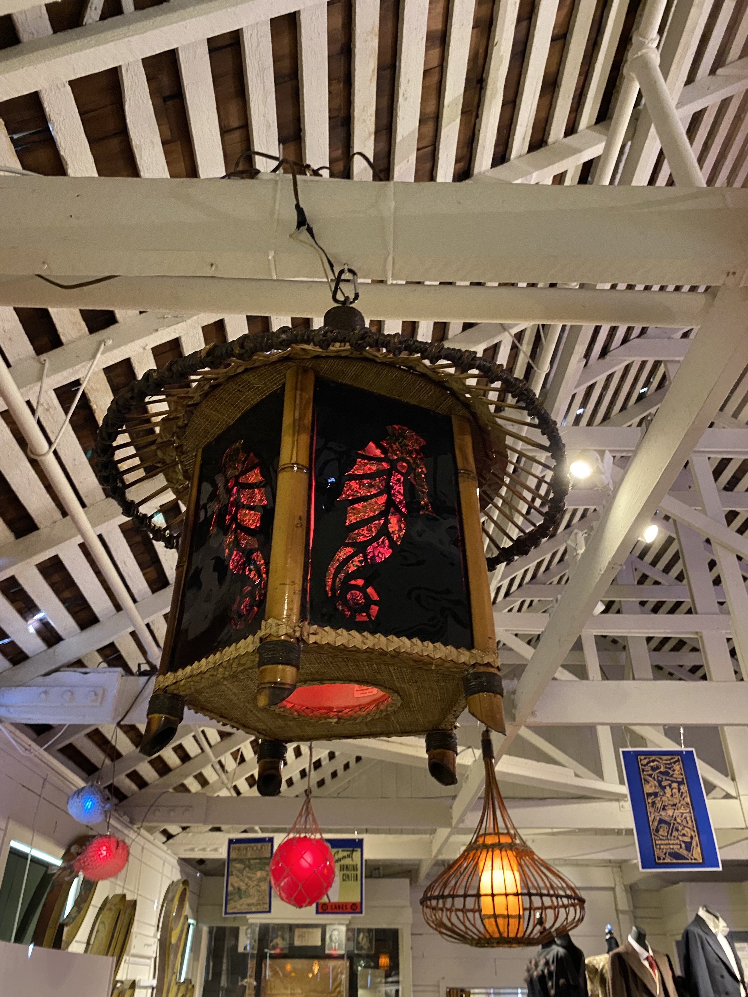 Decorative hanging lanterns in various shapes and colors displayed indoors.