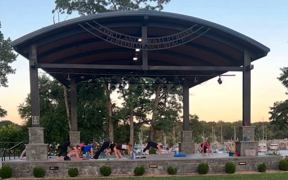 Lila Within yoga class on the Cortlandt Waterfront Performance Stage at sunset