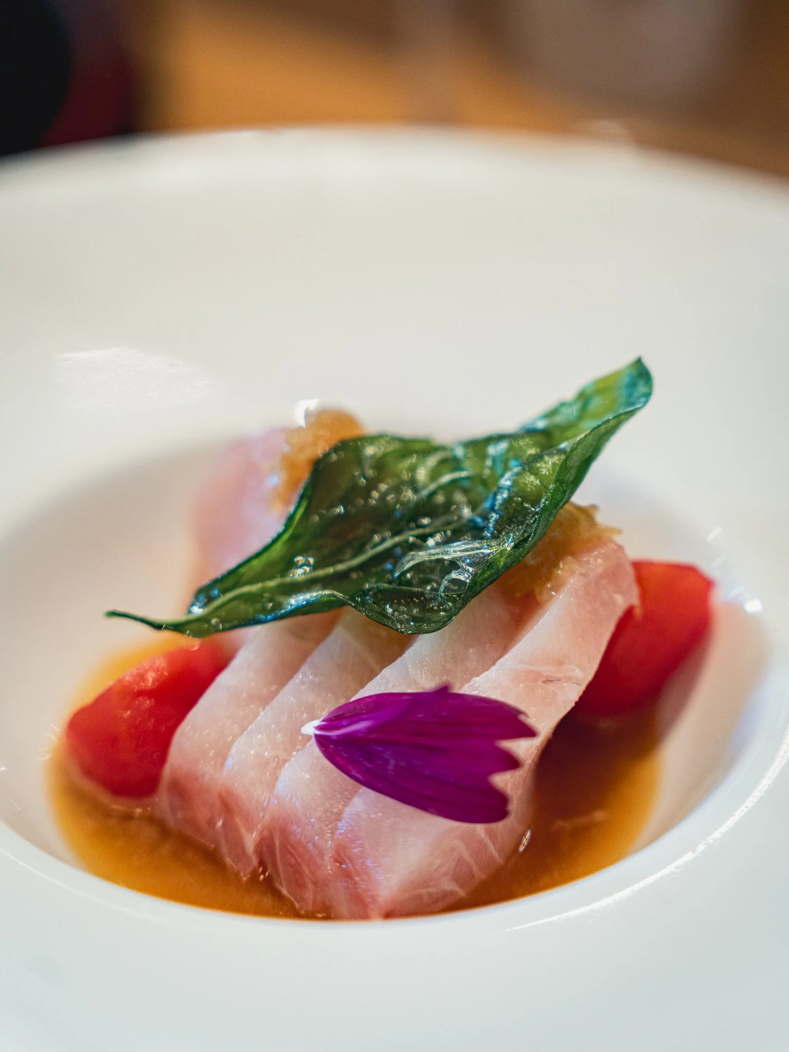 Elegant seasonal sashimi dish with floral garnish, highlighted by Visit Orlando as a top new dining experience at Kappo Tsan.