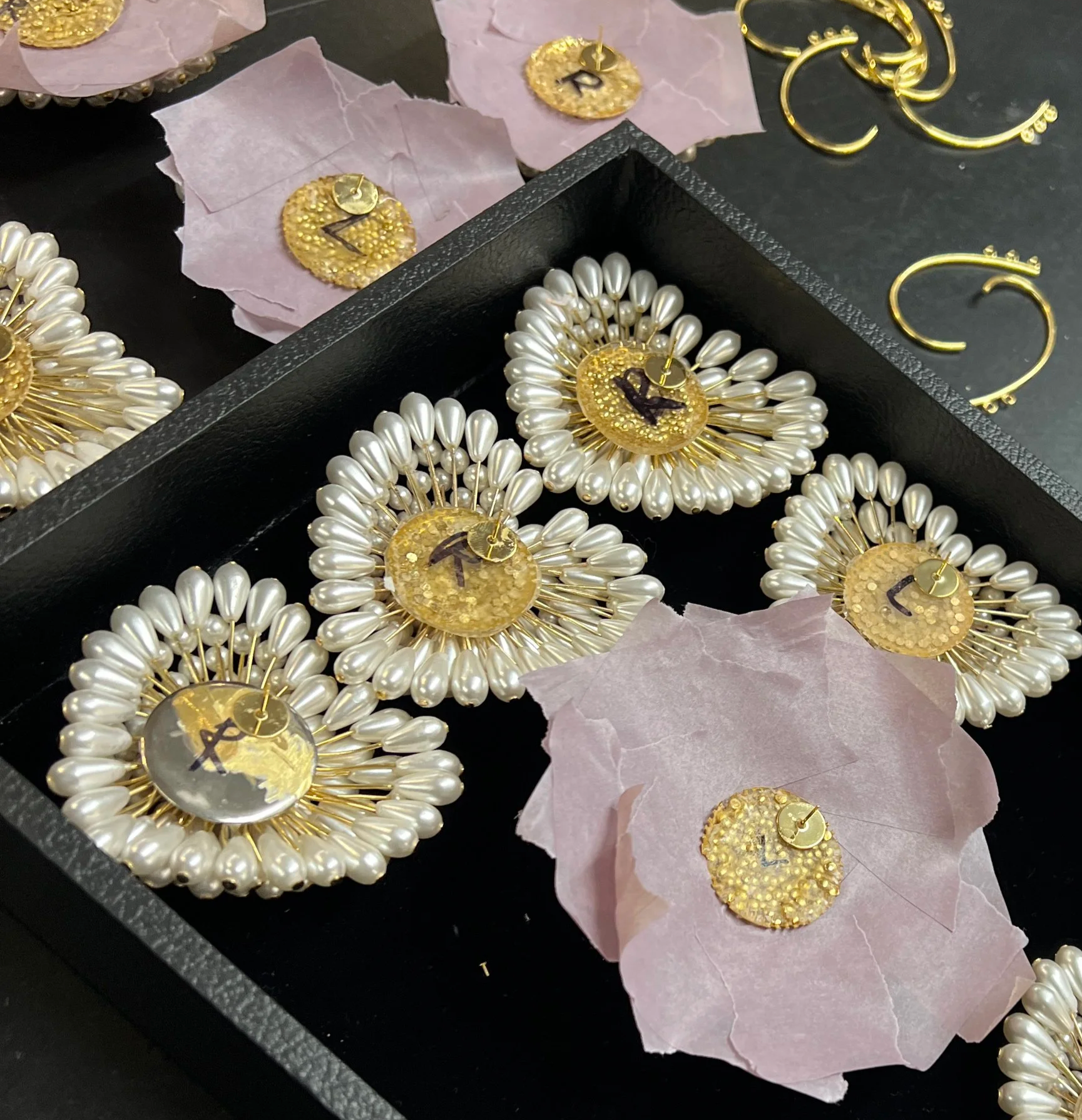 Worked with the entire team to hand-build pearl earrings, attaching each pearl head to metal rods to form the heart shape. Created the initial mockup before collaborating with the team on final production.
