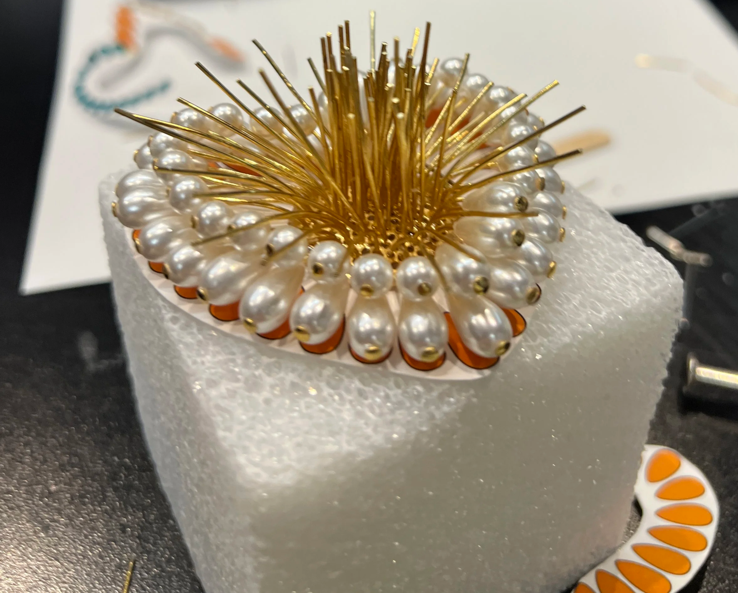 Worked with the entire team to hand-build pearl earrings, attaching each pearl head to metal rods to form the heart shape. Created the initial mockup before collaborating with the team on final production.