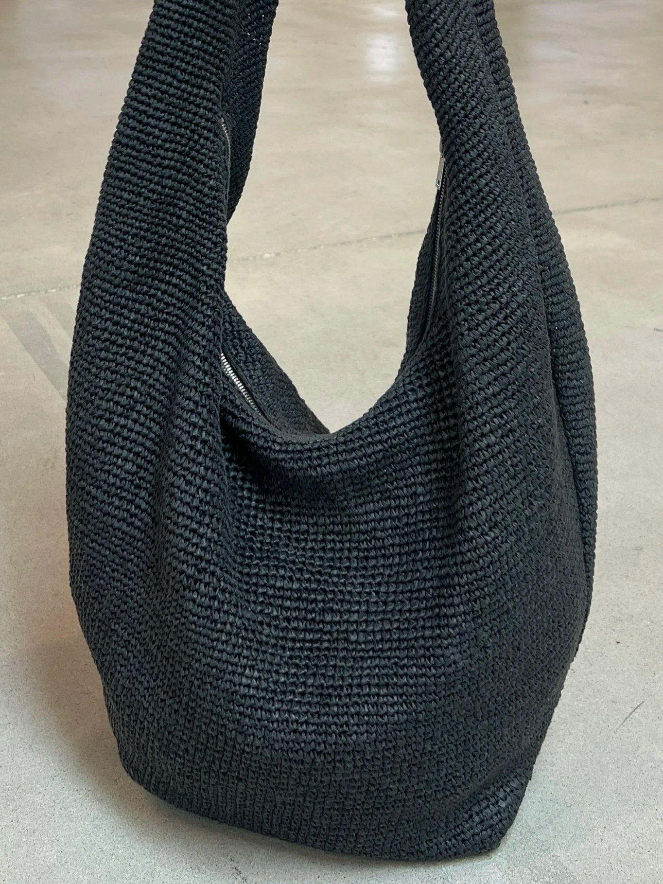 Drawing inspiration from a coworker’s raffia bag, we explored a casual hobo shape and experimented with a looser weave technique to create a more relaxed construction.