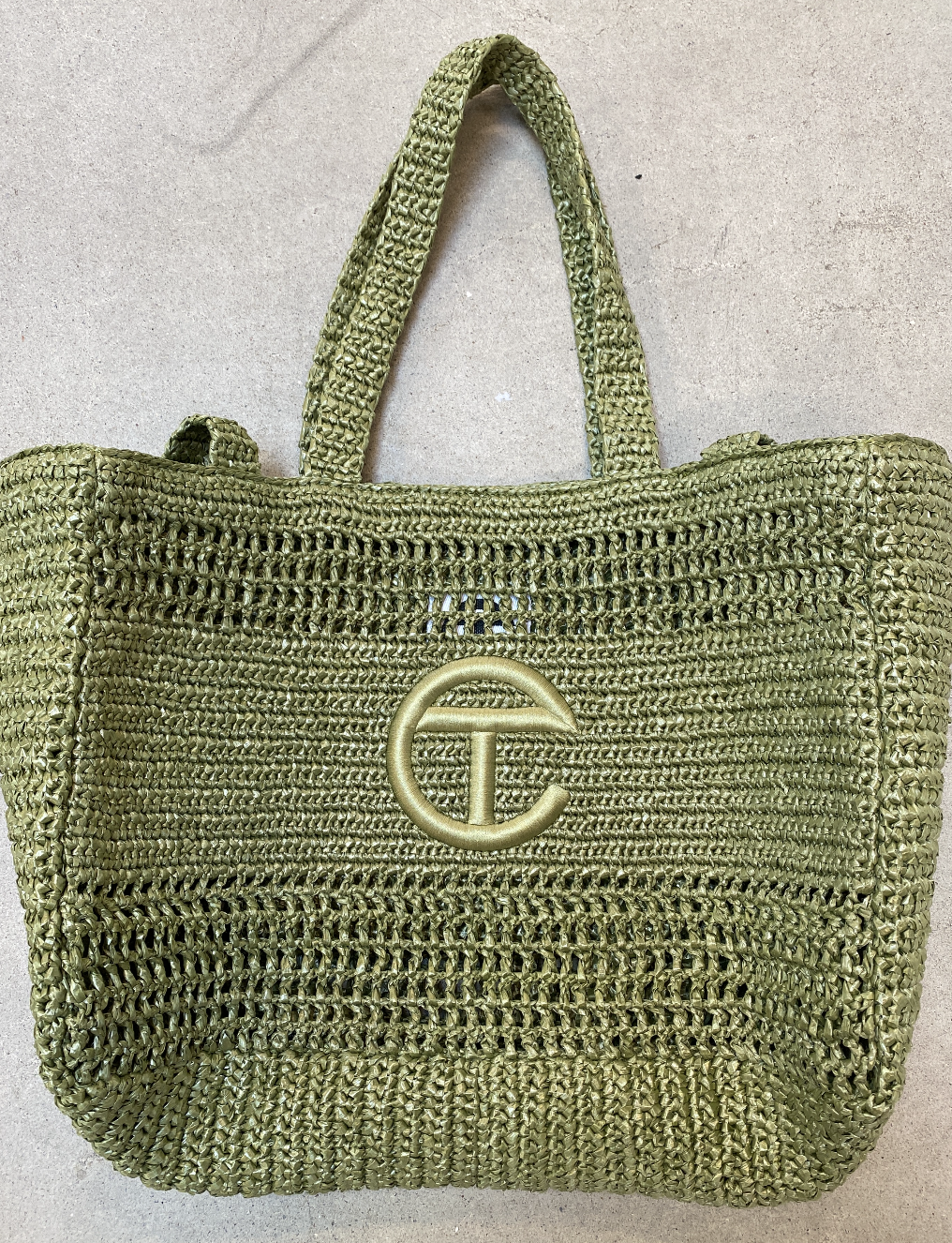 Early design exploration focused on embroidered logos and raffia, but both presented aesthetic and material limitations. The final direction evolved to recycled materials for a more seamless integration with the bag and stronger alignment with the br