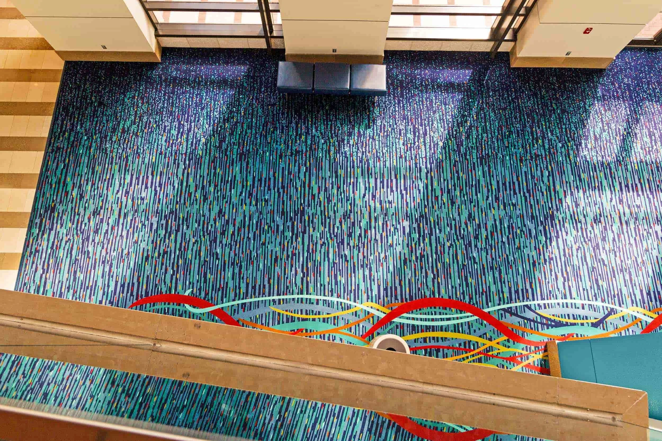 Large-scale hospitality carpet pattern across a public gathering space