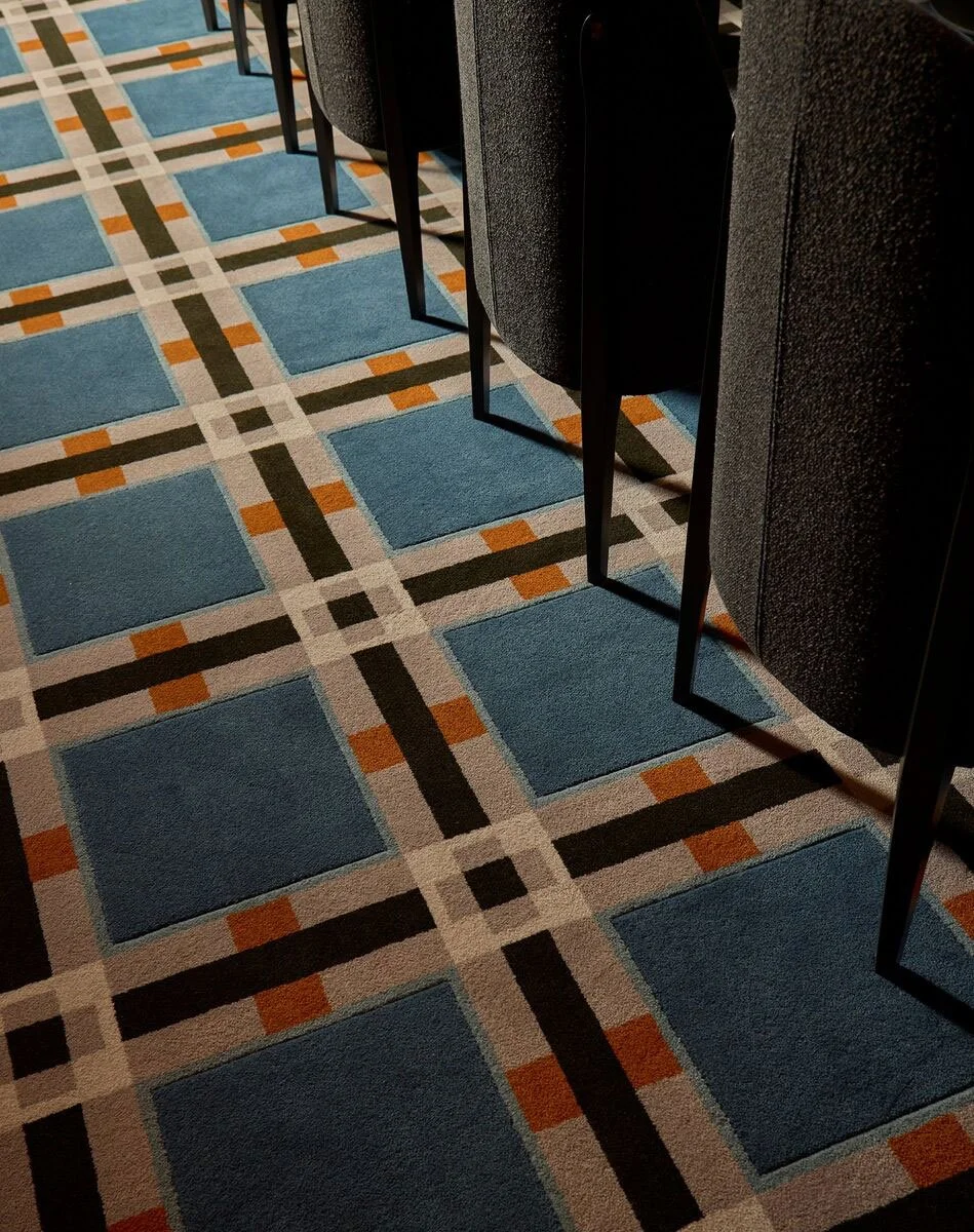 Close-up of geometric Axminster carpet pattern with hand-carving effect