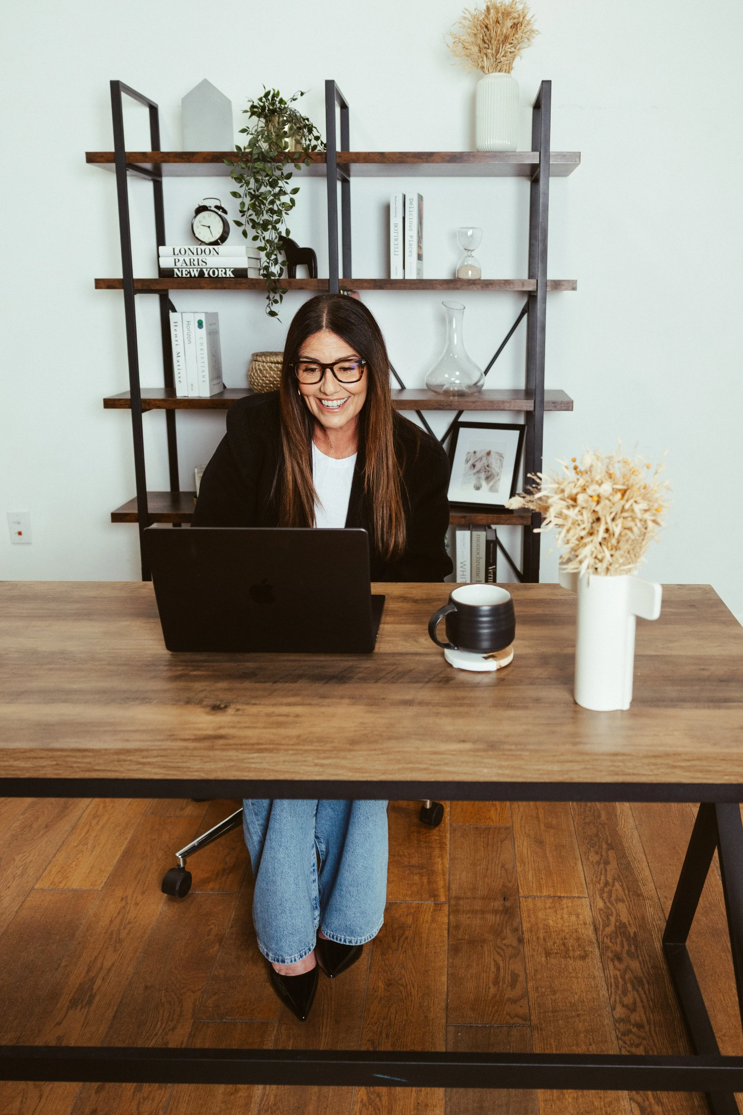 Nikki at desk with open laptop.