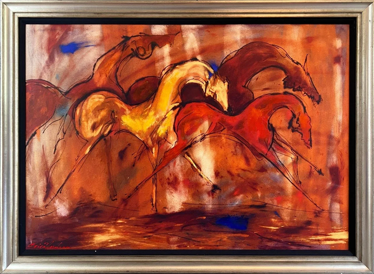 Abstract painting of three horses in warm tones, with black outline details, framed with a silver frame.