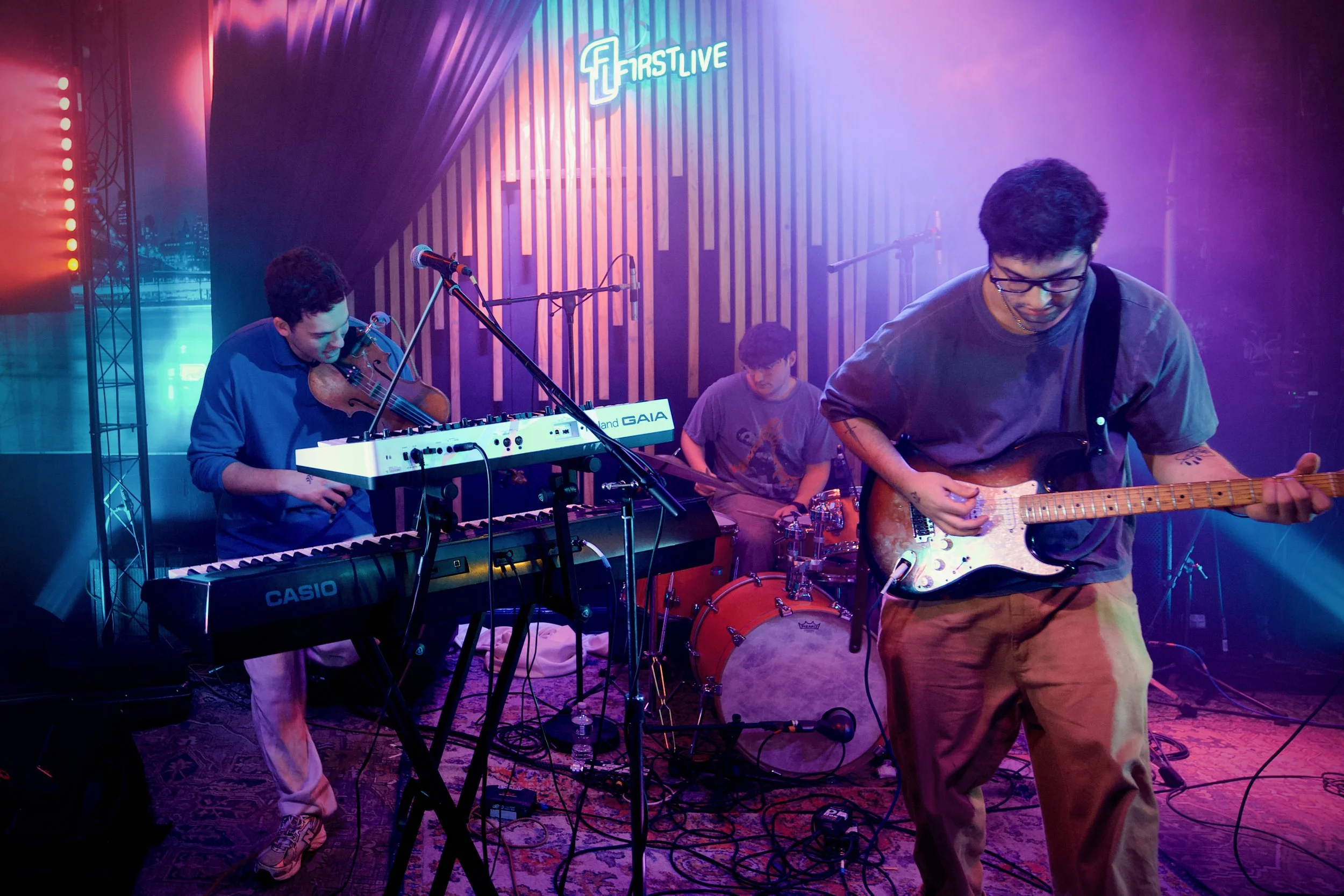 Good News Band performing live on stage with a keyboard, electric guitar, and drums New York City