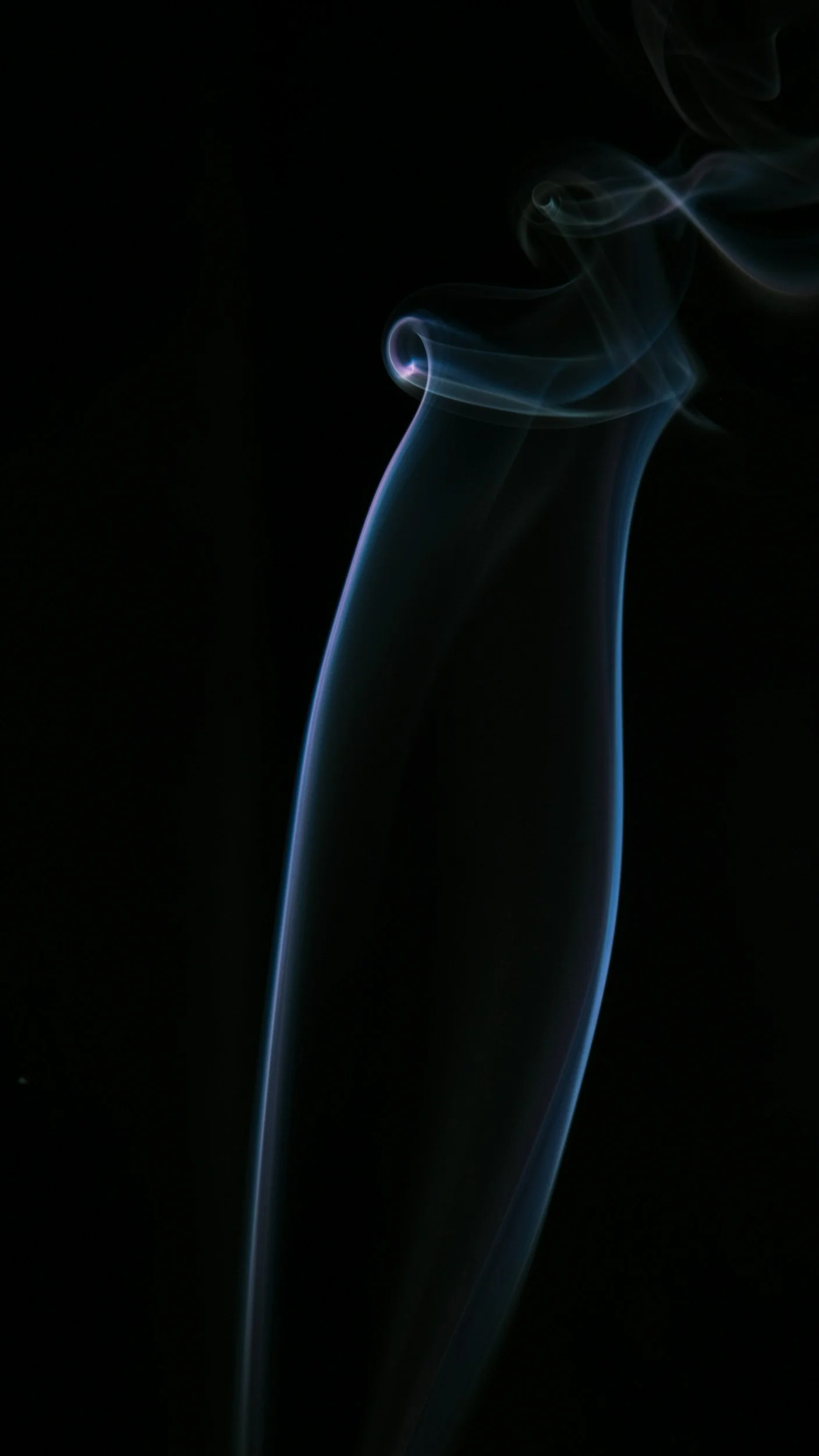 Thin wisps of blue and white smoke against a black background.