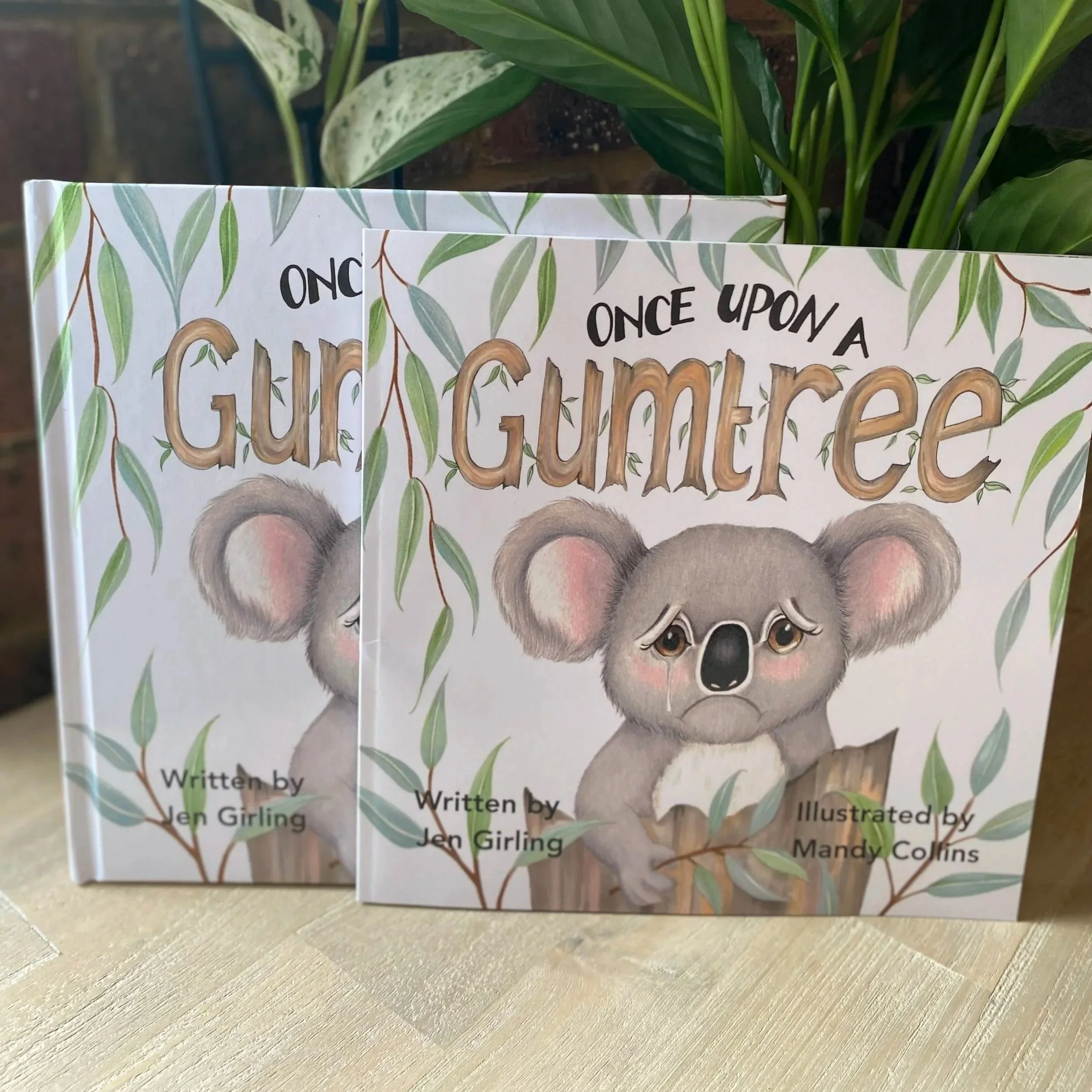 Softcover and Hardcover copies of Once Upon a Gumtree children's picture book stacked together.