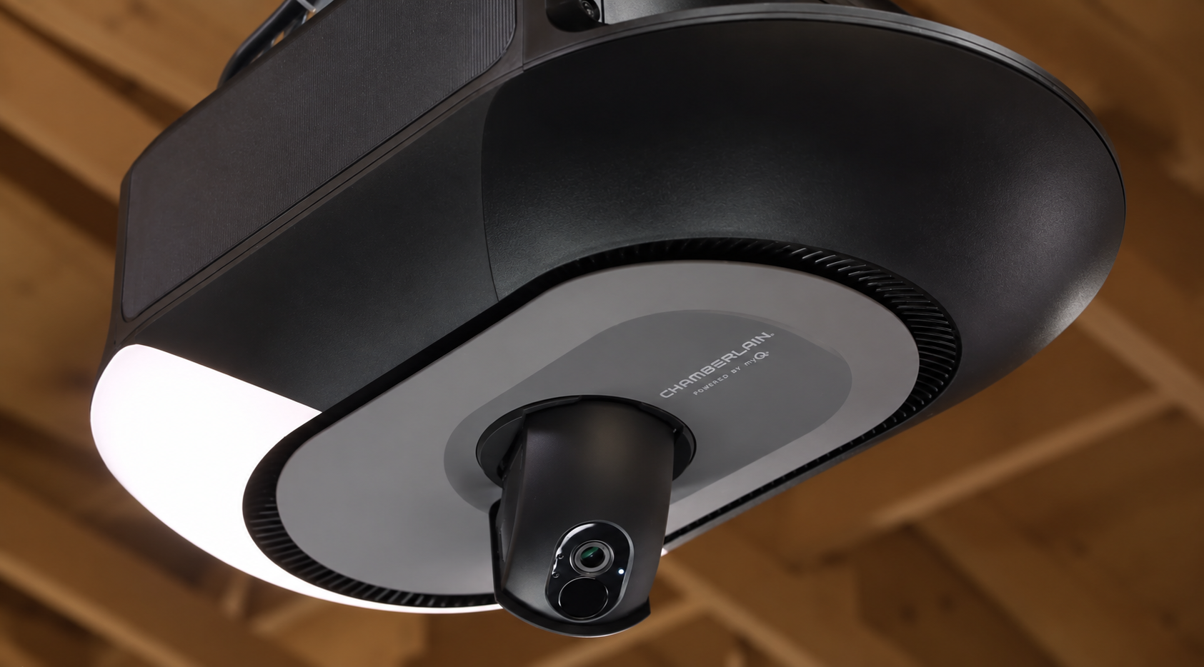 Ceiling-mounted overhead garage door opener with integrated lighting and camera