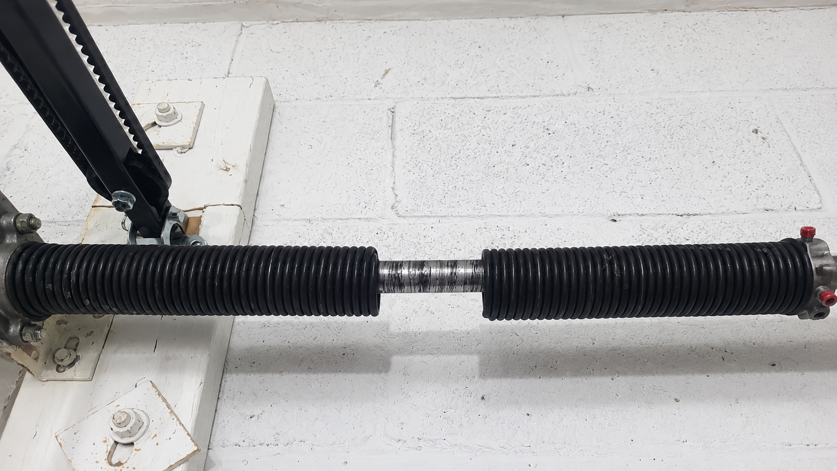 Broken garage door torsion spring requiring repair by Galaxy Doors in South Denver, Colorado