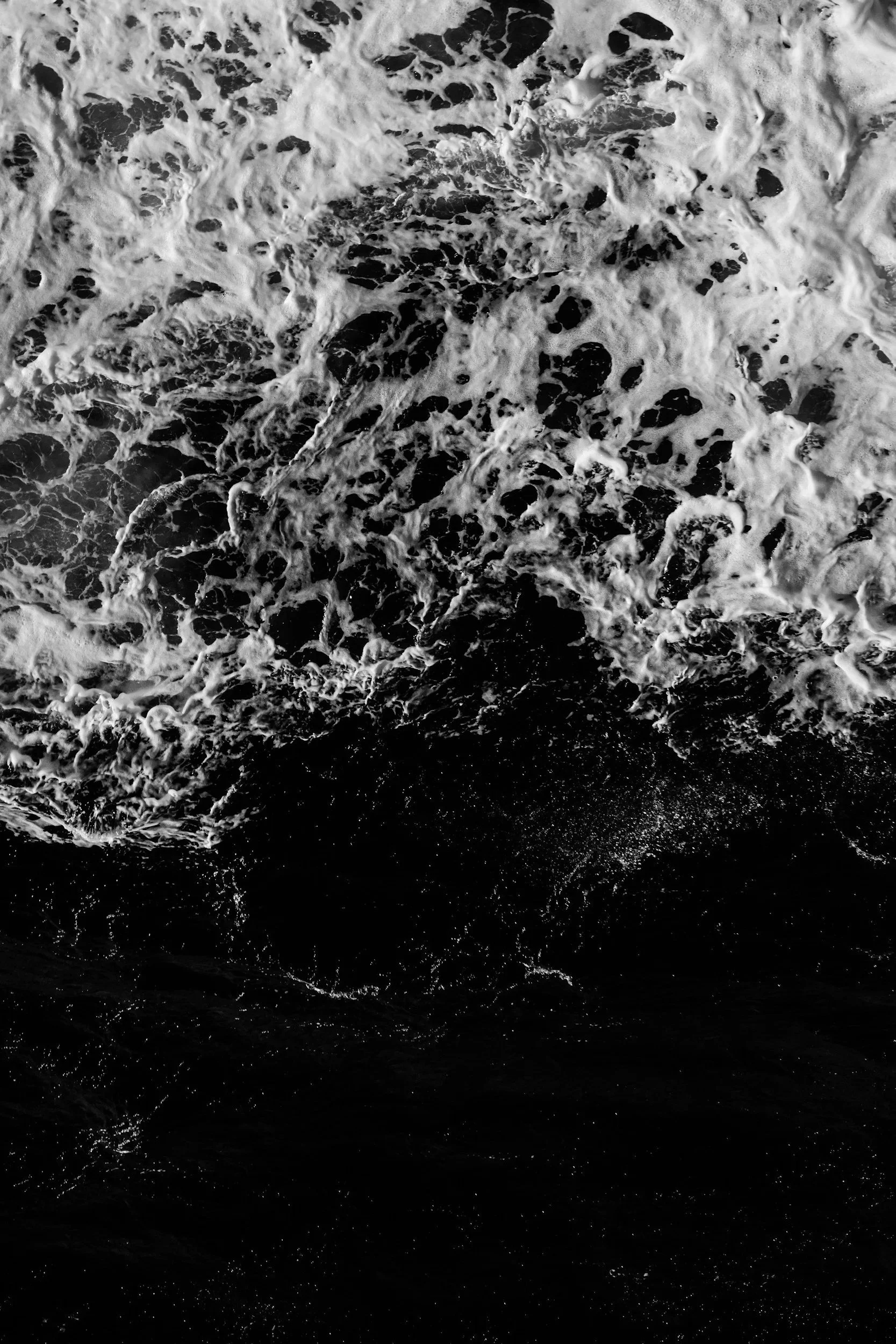 Black and white photo of ocean waves crashing.