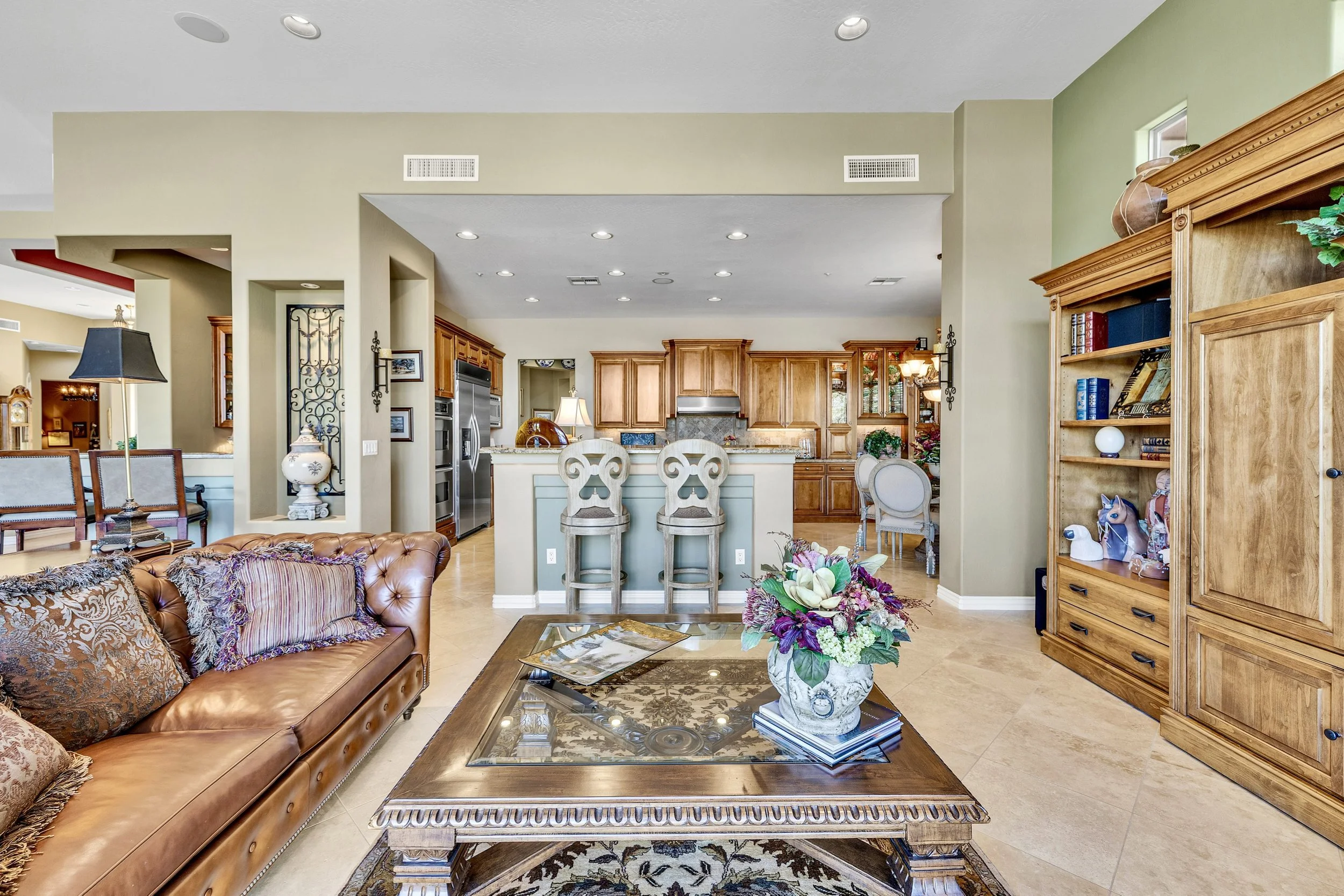 This Scottsdale, AZ home features a spacious open-concept living room and kitchen with elegant furnishings, showcased through professional real estate photography.