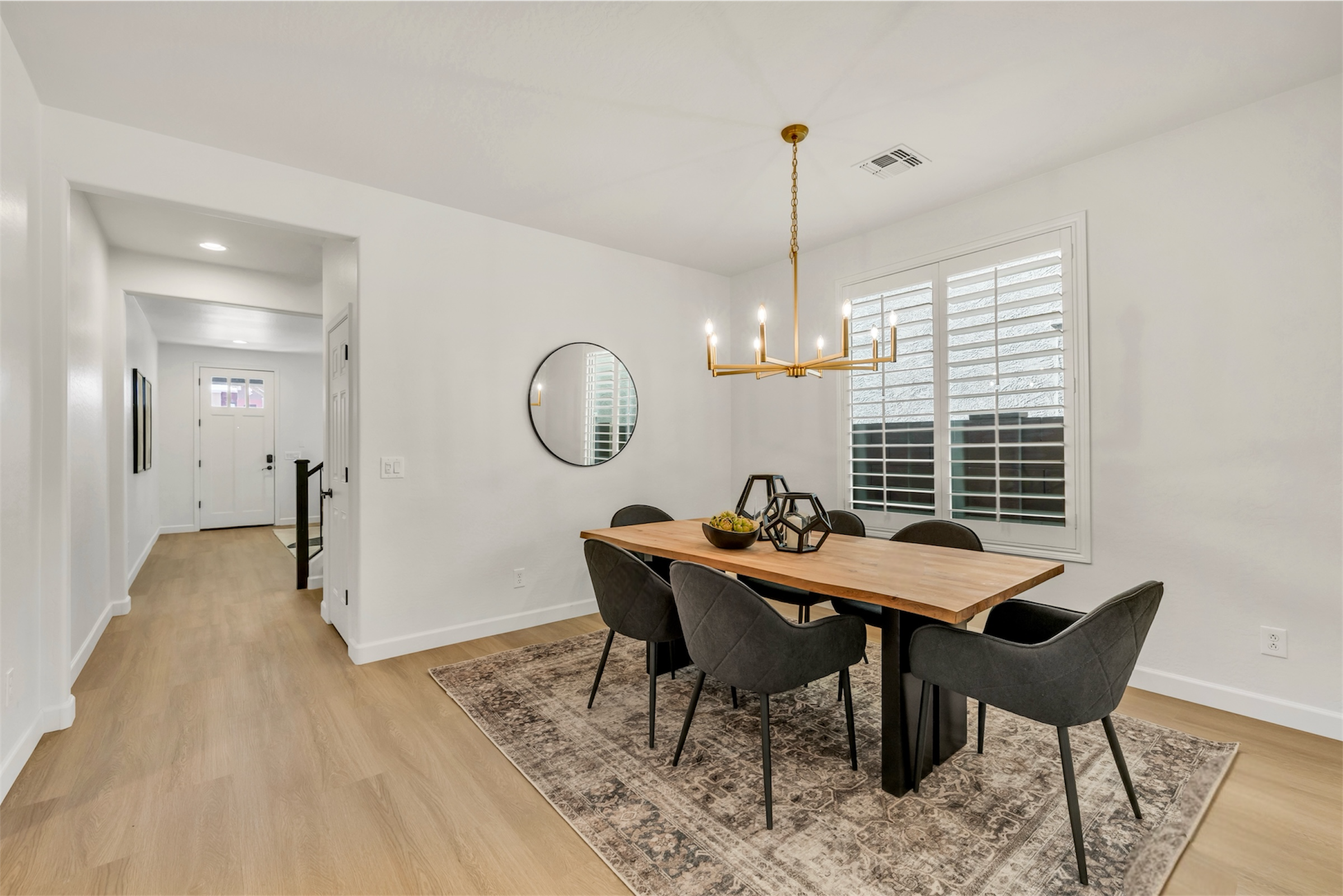 This dining room features modern fixtures and ample natural light, showcasing a beautiful home in Gilbert, AZ with professional real estate photography.