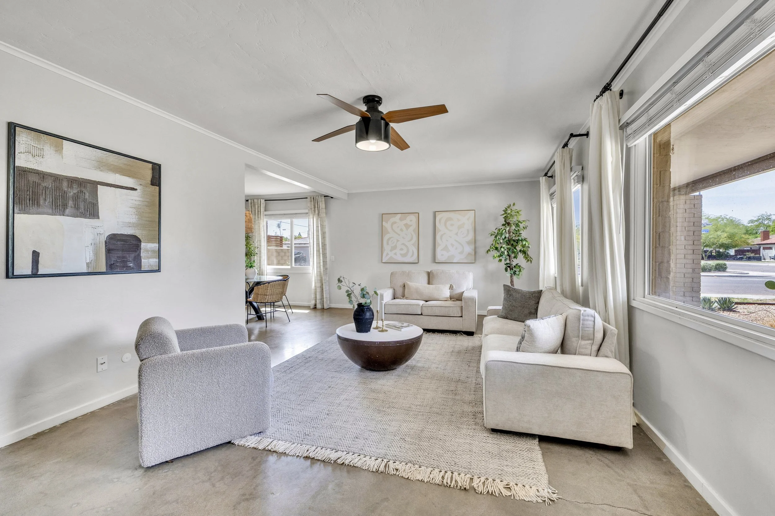 Bright living room with modern furniture and large windows in a Phoenix, AZ home captured with expert real estate photography.