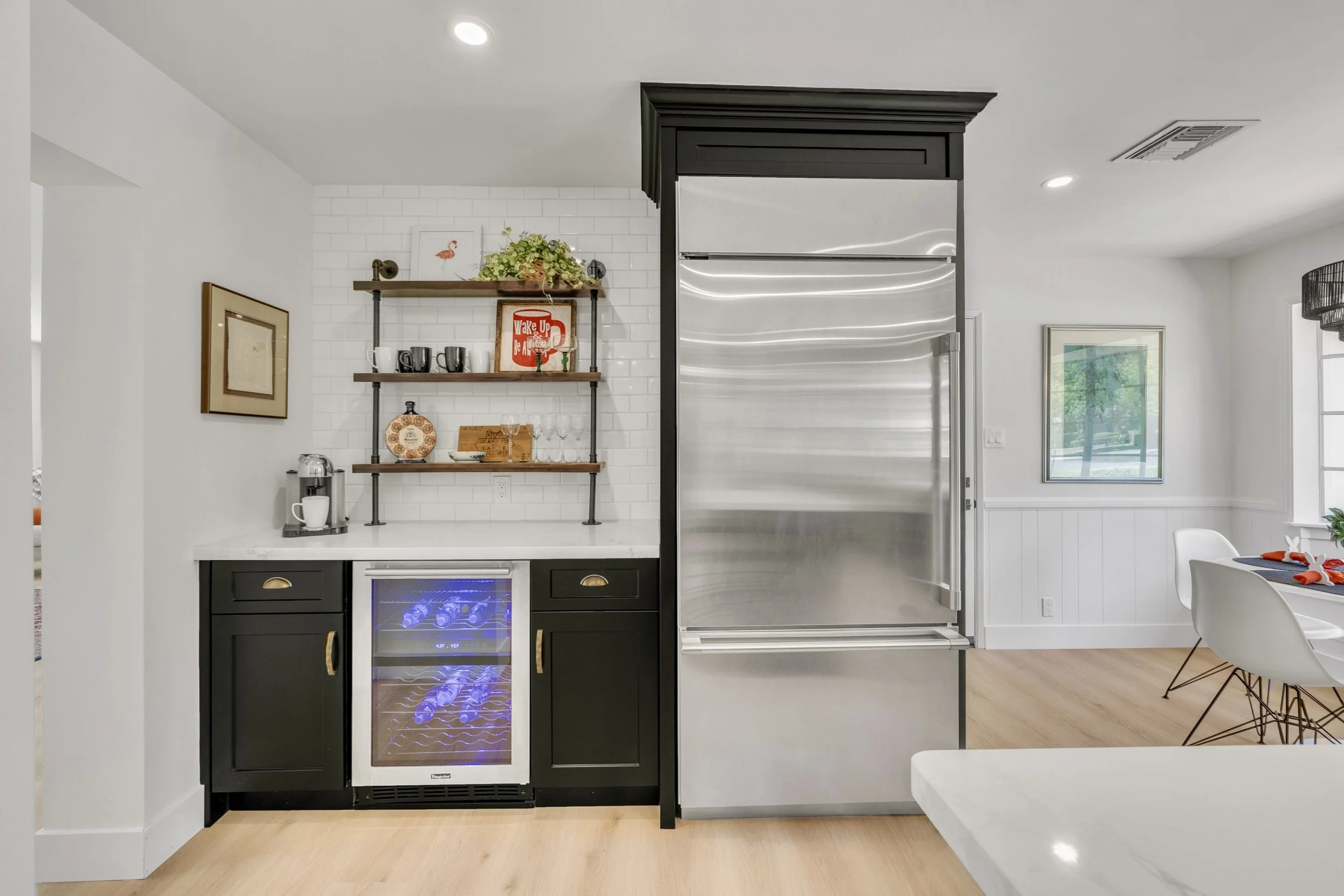 This Phoenix, AZ kitchen features a modern design with stainless steel appliances and a wine cooler, perfectly captured through expert real estate photography.