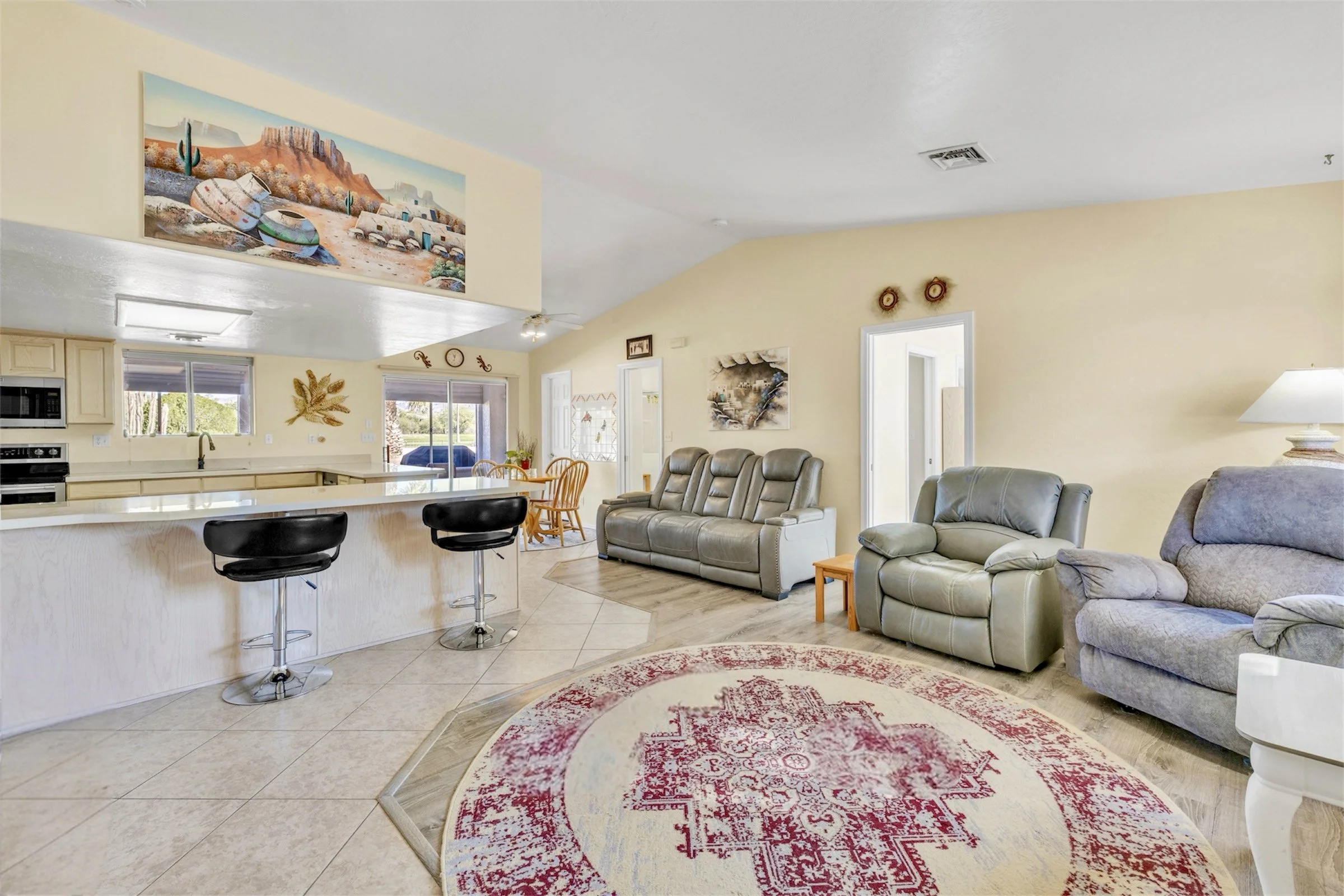Spacious open-plan living room and kitchen with modern furnishings captured in high-quality real estate photography in Queen Valley, AZ.
